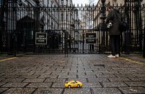 Greenpeace activists hold remote-controlled car race outside London's 10 Downing Street.