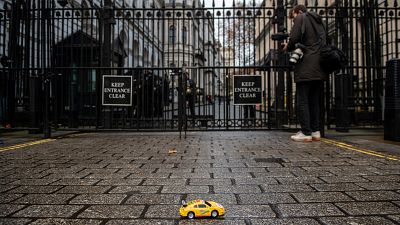 Greenpeace activists hold remote-controlled car race outside London's 10 Downing Street. Greenpeace activists hold remote-controlled car race outside London's 10 Downing Street.