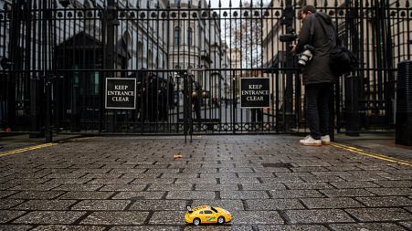 Greenpeace activists hold remote-controlled car race outside London's 10 Downing Street.
