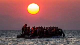 In this file photo taken on Aug. 13, 2015, migrants on a dinghy approach the southeastern island of Kos, Greece