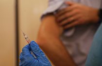 A nurse prepares to inject flu vaccine Jacopo Leoni at the Museum of science and technology in Milan, Italy, Wednesday, Nov. 4, 2020.