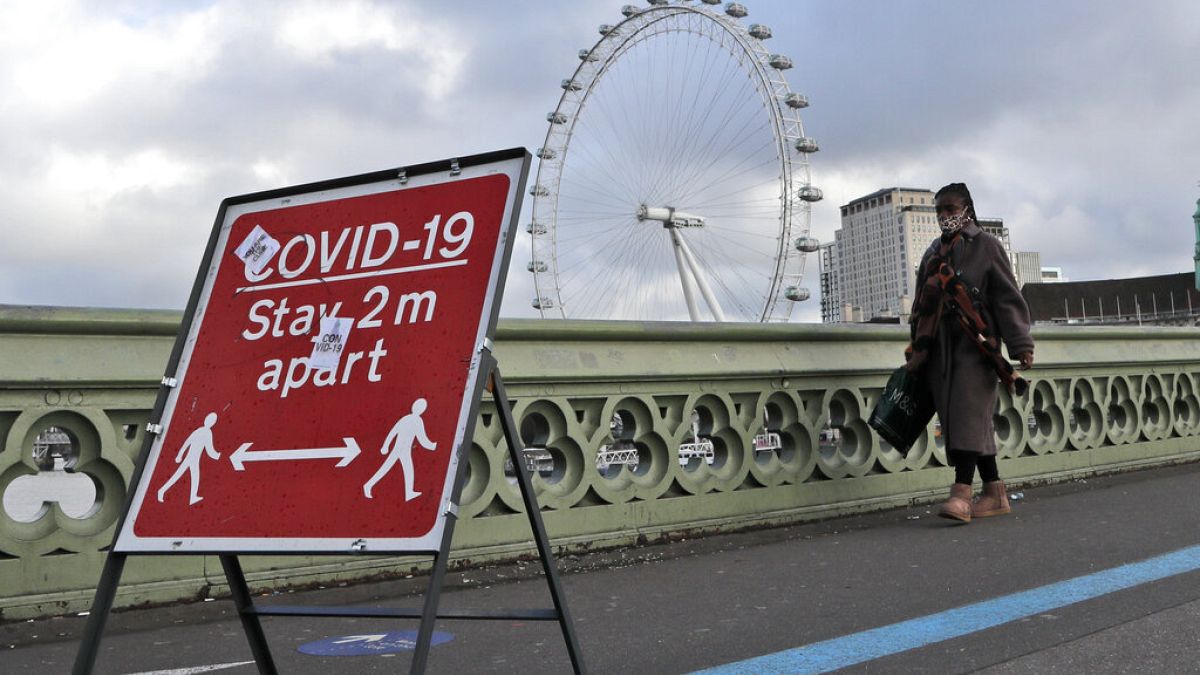 A woman walks over Westminster Bridge during the second coronavirus lockdown in London, Tuesday, Nov. 10, 2020
