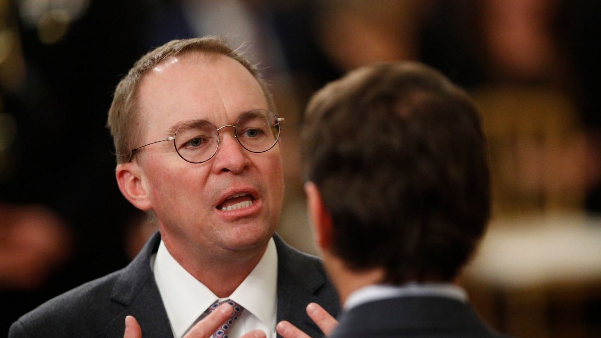 White House acting chief of staff Mick Mulvaney mingles with other attendees in the in the East Room of the the White House in Washington, Thursday, Feb. 6, 2020, before Presi