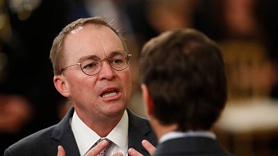 White House acting chief of staff Mick Mulvaney mingles with other attendees in the in the East Room of the the White House in Washington, Thursday, Feb. 6, 2020, before Presi