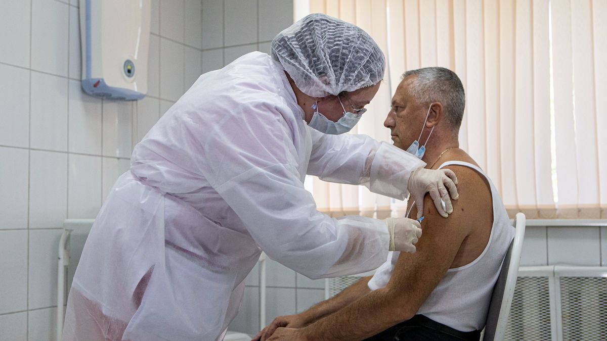 Sept. 15, 2020, file photo, a Russian medical worker administers a shot of Russia's experimental Sputnik V coronavirus vaccine in Moscow, Russia