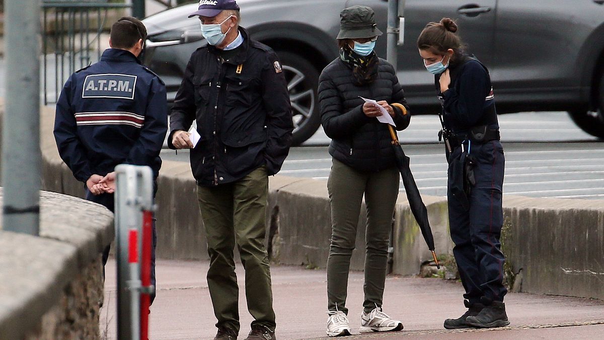 Police officers check documents to ensure that confinement measures due to the coronavirus are upheld in Saint Jean de Luz on Nov.3, 2020.