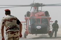 Multinational Force and Observers (MFO) helicopter and personnel work at the site of the French military transport aircraft crash in the Sinai region of Egypt in 2007 