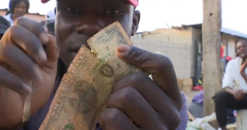 Zimbabwe currency dealers repair worn out dollar notes