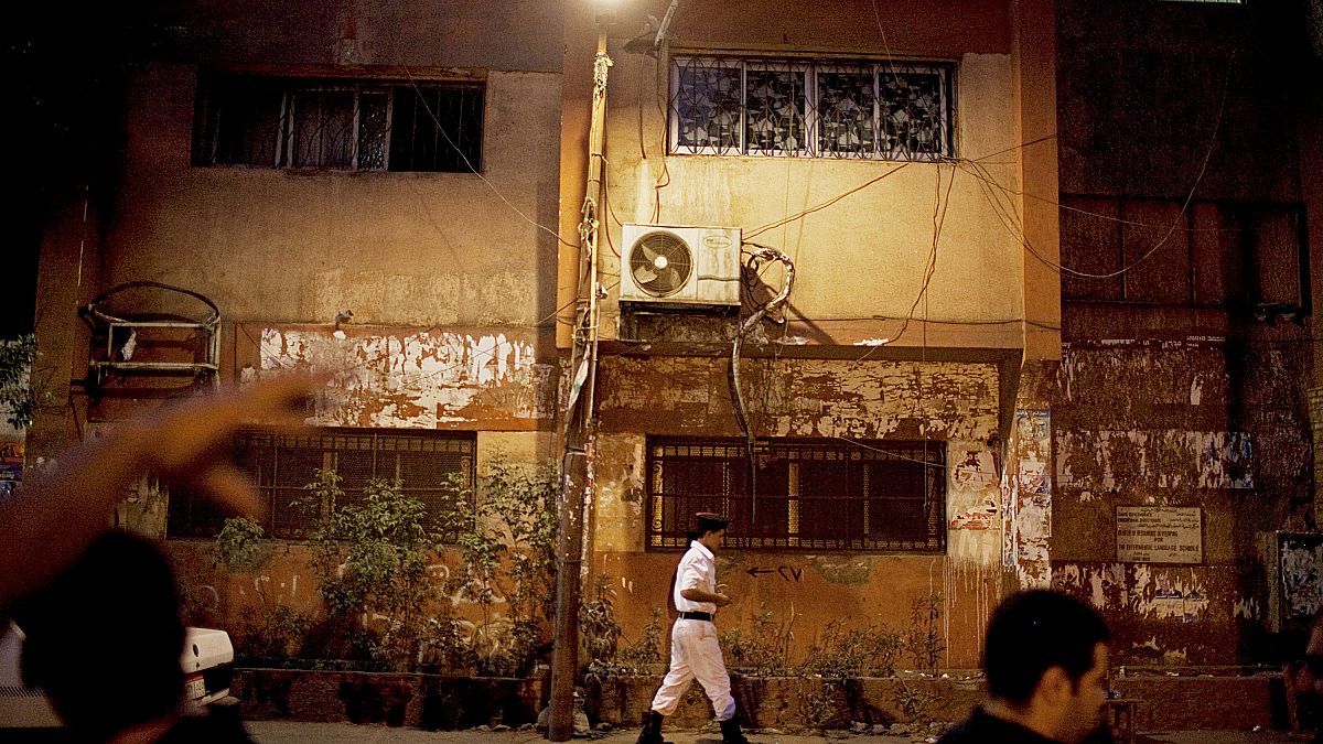 An Egyptian police officer stands outside a polling station in the Abdeen area of Cairo, Egypt on Sunday, June 17, 2012