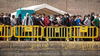 Migrants from a group of 1300 rescued from different boats remain in the port of Arguineguin while being cared for by the Spanish Red Cross