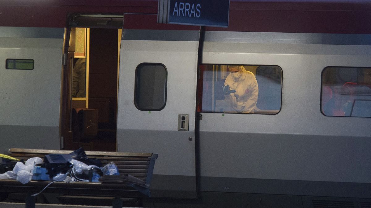 A police officer videos the crime scene inside a Thalys train at Arras train station, northern France, after a gunman opened fire with an automatic weapon.