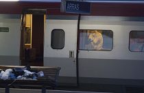 A police officer videos the crime scene inside a Thalys train at Arras train station, northern France, after a gunman opened fire with an automatic weapon.