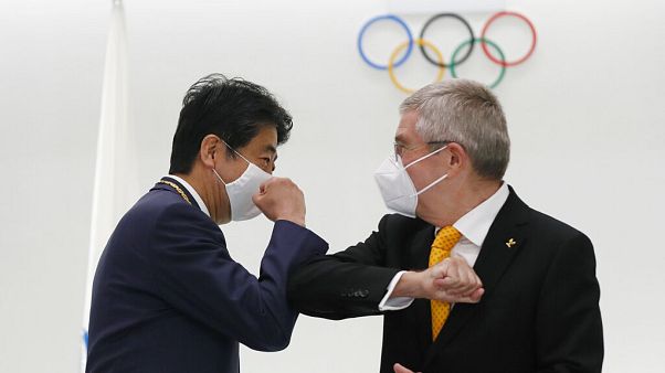 Former Japan's Prime Minister Shinzo Abe, left, and Thomas Bach, President of the International Olympic Committee (IOC), bump elbows in Tokyo Former Japan's Prime Minister Shinzo Abe, left, and Thomas Bach, President of the International Olympic Committee (IOC), bump elbows in Tokyo