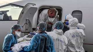 Medical staff load a patient affected with COVID-19 aboard a medical plane at Bron airport near Lyon, central France, Monday, Nov. 16, 2020.