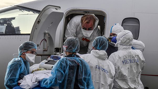 Medical staff load a patient affected with COVID-19 aboard a medical plane at Bron airport near Lyon, central France, Monday, Nov. 16, 2020. Medical staff load a patient affected with COVID-19 aboard a medical plane at Bron airport near Lyon, central France, Monday, Nov. 16, 2020.