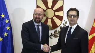 European Council President Charles Michel, left, shakes hands with North Macedonia's President Stevo Pendarovski, right, in Skopje,North Macedonia, Friday, Jan. 24, 2020.