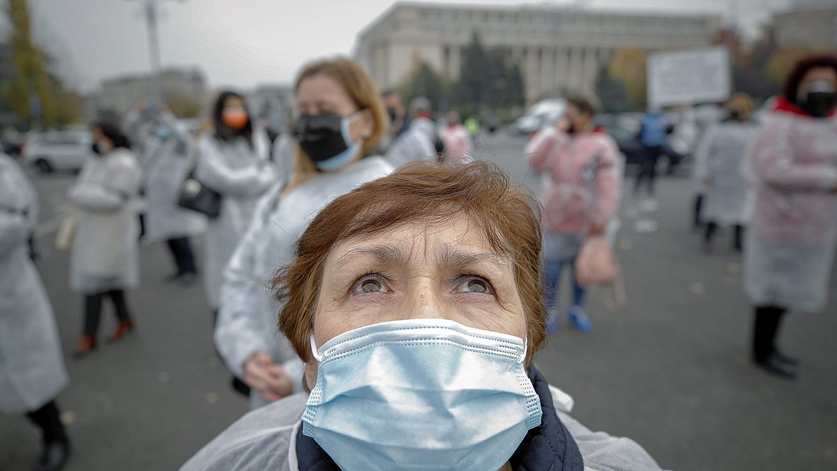 A medical worker, wearing a mask for protection against the COVID-19 infection