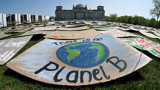 Activists place thousands of protest placards in front of the Reichstag building in Berlin on April 24, 2020.