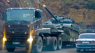 A truck carries an Armenian tank during the withdrawal of Armenian troops near the border between Nagorno-Karabakh and Armenia, Friday, Nov. 13, 2020.