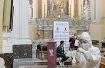 A medical operator prepares to perform COVID-19 test swabs in the Church of San Severo Outside the Walls, in the heart of Naples.