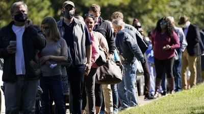Voters brave a bright sun as they wait to cast their ballots in Mississippi, US. Voters brave a bright sun as they wait to cast their ballots in Mississippi, US.