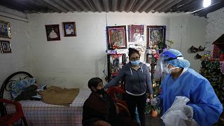 Dr Delia Caudillo, right, gives medical guidance to 82-year-old Modesta Caballero, left, after a medical team tested Caballero for COVID-19 at her home in Mexico City.