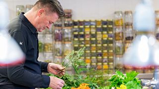 Belgian Rene Mathieu, chief of La Distillerie, prepares vegetables in the kitchen of the  restaurant at Bourlinsgter's castle.