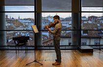 A musician in a face mask plays the violin at a rehearsal at the Teatro Real in Madrid, Spain, Friday, November 13, 2020.