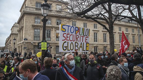 Demonstrators wearing masks stage a protest by the National Assembly against the security bill in Paris, Tuesday, November 17, 2020. Demonstrators wearing masks stage a protest by the National Assembly against the security bill in Paris, Tuesday, November 17, 2020.