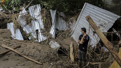 A man looks what is left of his home among the mud and debris after the Chamelecon River overfloow due to heavy rains caused by Hurricane Iota.