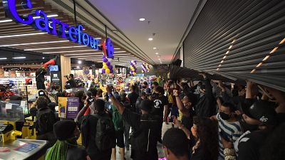Demonstrators invade a supermarket Carrefour in Sao Paulo.