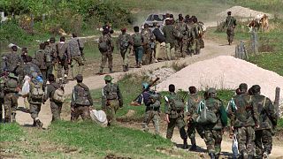 In this Sept. 28, 1995. file photo, a line of Bosnian government troops makes its way to the front-line near Mrkonjic Grad 120kms (80mls) north west of Sarajevo, Bosnia.