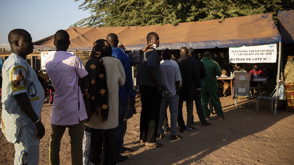 People line up to vote in Burkina Faso's presidential and legislative elections in Ouagadougou Sunday November 22, 2020.