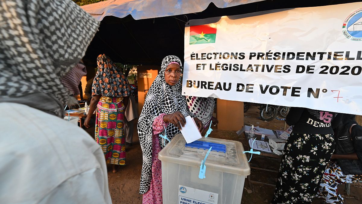 A voter casts her ballot at a polling station in Ouagadougou, during Burkina Faso's presidential and legislative elections.