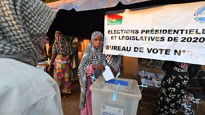 A voter casts her ballot at a polling station in Ouagadougou, during Burkina Faso's presidential and legislative elections.