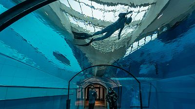 A diver swims in the world's deepest swimming pool in Mszczonow, Poland, on November 21, 2020. A diver swims in the world's deepest swimming pool in Mszczonow, Poland, on November 21, 2020.