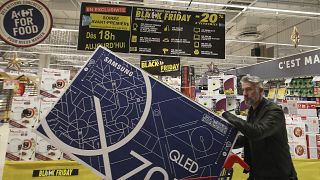 In this photo taken on Nov, 28, 2019, a customer walks in the Carrefour Shopping center on the eve of the Black Friday event, in Cesson, France.