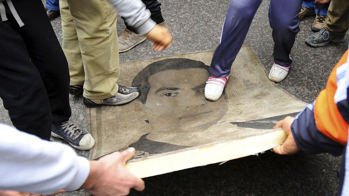 في الذكرى الثالثة لثورة 14 يناير/جانفي محتجون يدوسون على صورة الرئيس الأسبق زين العابدين بن علي. 2014/01/14