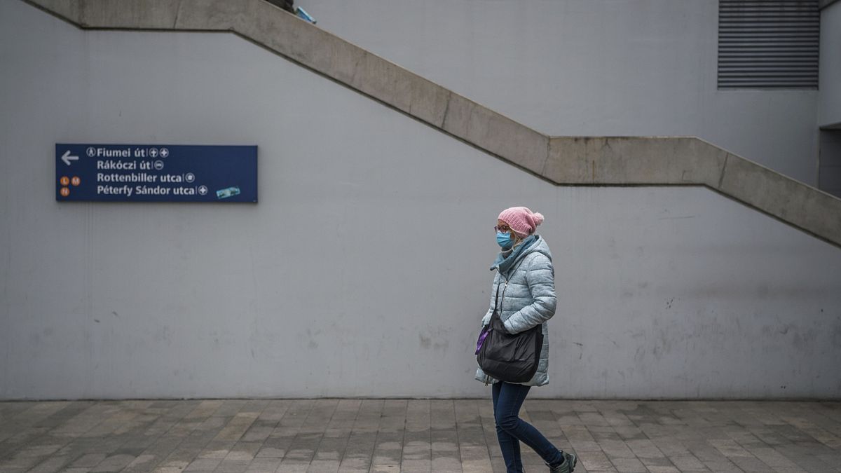 A pedestrian wears a protective mask at the Baross square metro station in Budapest, Hungary, Wednesday, Nov. 11, 2020.