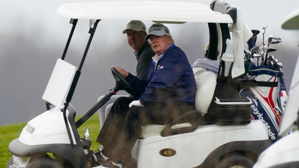 Donald Trump cheered by supporters as he heads to golf course