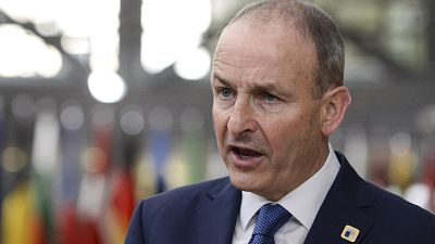 Ireland's Prime Minister Micheal Martin speaks with the media as he arrives for an EU summit in Brussels, Friday, Oct. 16, 2020. 