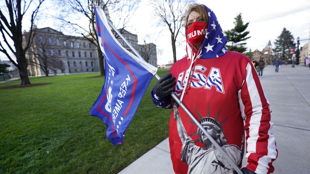 Lisa McClain, a President Trump supporter, walks near the Capitol building in Lansing, Mich., Monday, Nov. 23, 2020. 