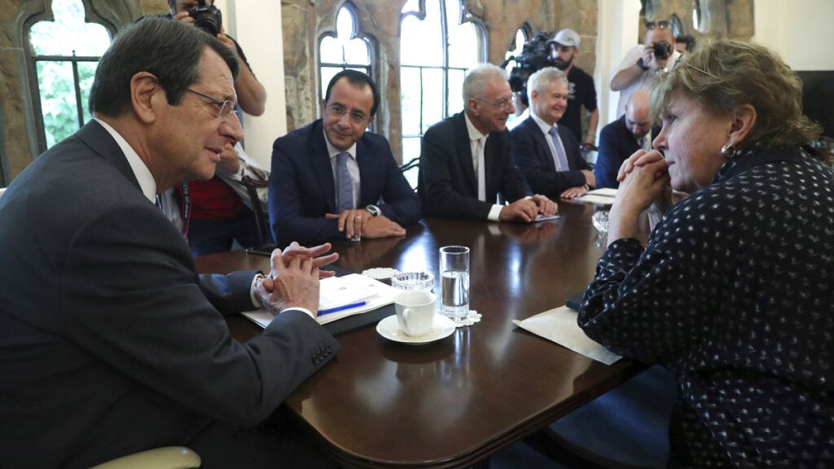 UN envoy Jane Holl Lute, right, talks with Cyprus' president Nikos Anastasiades