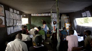 Teaching French to immigrants in a camp near Calais in France