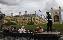 Tourists enjoy a punt on the river Cam, in Cambridge, England.