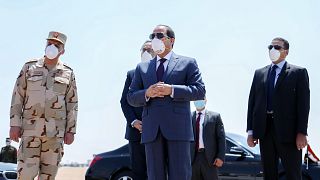 Egyptian President Abdel Fattah al-Sisi(C) wearing a facemask as a protective measure against the novel coronavirus, during a visit to the Huckstep military base