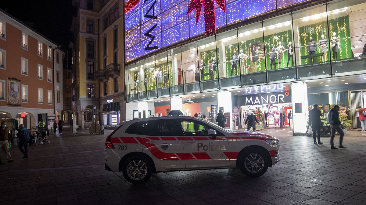 A police car in the area where a stabbing occurred in the department store, in Lugano, Switzerland, Tuesday, Nov. 24, 2020
