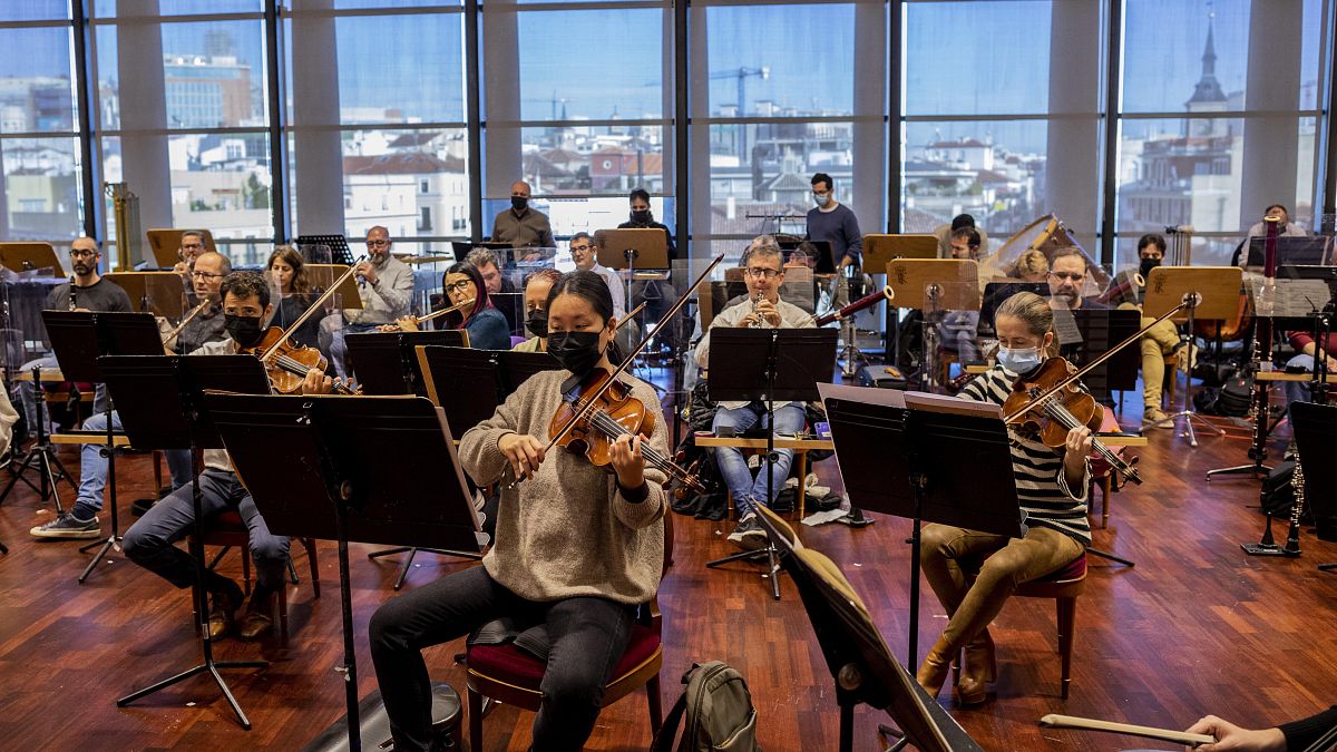 Musicians wearing face masks or behind screens due COVID-19 protocol measures rehearse at the Teatro Real in Madrid, Spain.