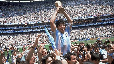 Maradona brandissant le trophée de la Coupe du monde de football, après la victoire de l'Argentine 3-2 sur la RFA, le 29 juin 1986 à Mexico