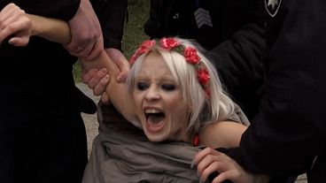 Femen activist shouts "No to violence!" 